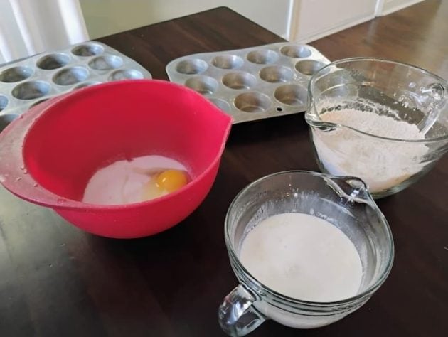 Mixing bowls with ingredients for flax muffins on a table.